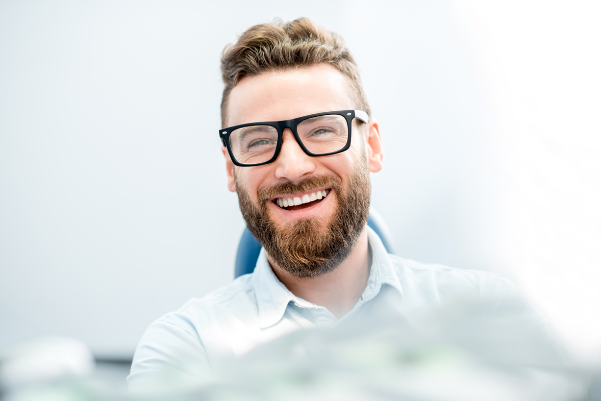 AdobeStock_141987377-Handsome-businessman-with-great-smile-sitting-on-the-dental-chair